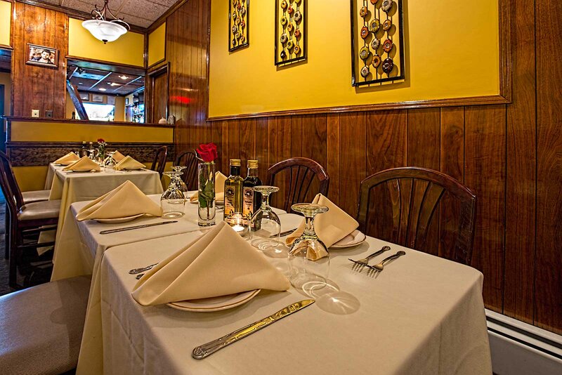 Dining room - showing four tables white table clothes